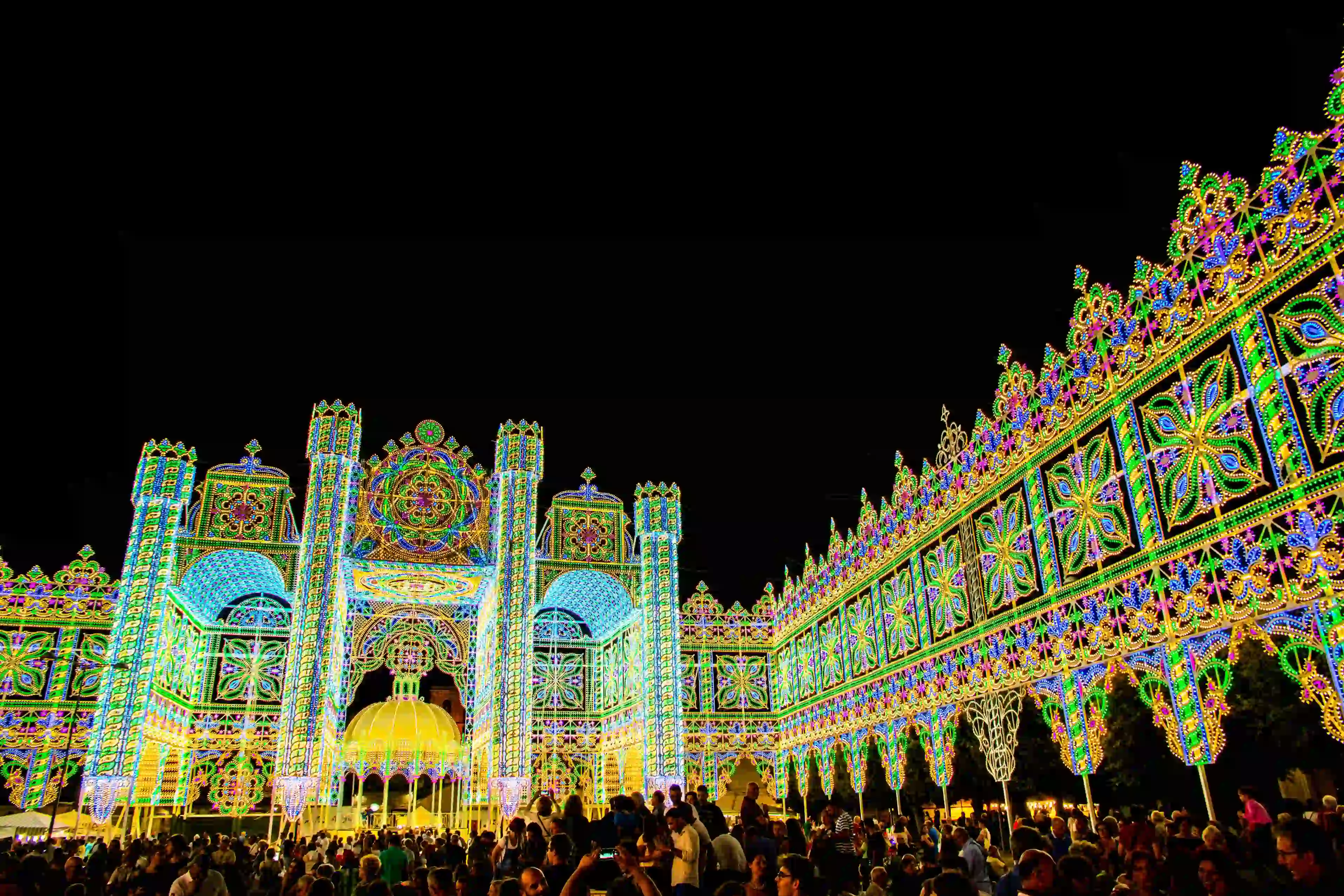 Colorful Salento festival lights illuminating streets in Puglia, Italy, showcasing traditional decorations and culture